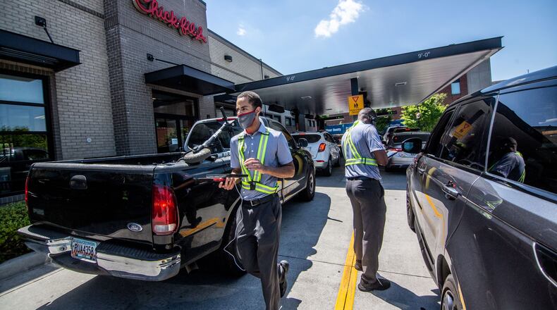 Employees direct traffic and take orders outside the Chick-fil-A on Northside Drive in Atlanta on Monday April 19, 2021. Sales for the overall Chick-fil-A chain were up last year, even with the pandemic, compared to the year before, according to company disclosure documents. STEVE SCHAEFER FOR THE ATLANTA JOURNAL-CONSTITUTION