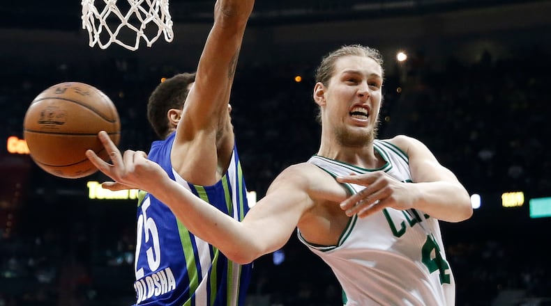 Boston Celtics center Kelly Olynyk (41) passes behind Atlanta Hawks forward Thabo Sefolosha (25) during Boston’s 103-101 win Friday, Jan. 13, 2017, in Atlanta.