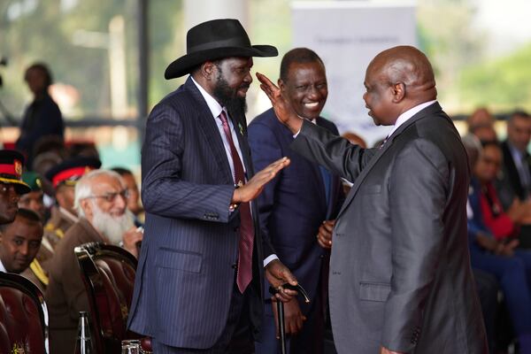 FILE - South Sudanese president Salva Kiir Mayardit, left, shakes hands with Pagan Amum Okiech, leader of the Real-SPLM group, during the launch of high-level peace talks for South Sudan at State House in Nairobi, Kenya, on Thursday, May 9, 2024. (AP Photo/Brian Inganga)