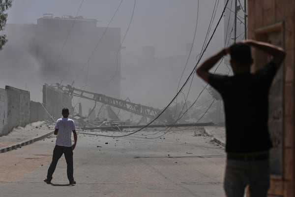 Palestinians look at the damage of a house destroyed by an Israeli strike in Deir al-Balah, central Gaza Strip, Monday, June 16, 2025. (AP Photo/Abdel Kareem Hana)