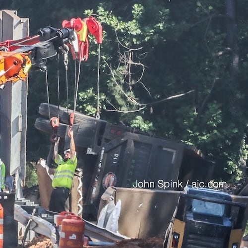 A sound barrier on I-75N is installed after officials said a tractor-trailer went through the wall. (John Spink/AJC file)