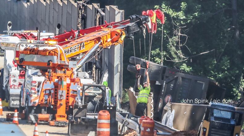A sound barrier on I-75N is installed after officials said a tractor-trailer went through the wall. (John Spink/AJC file)