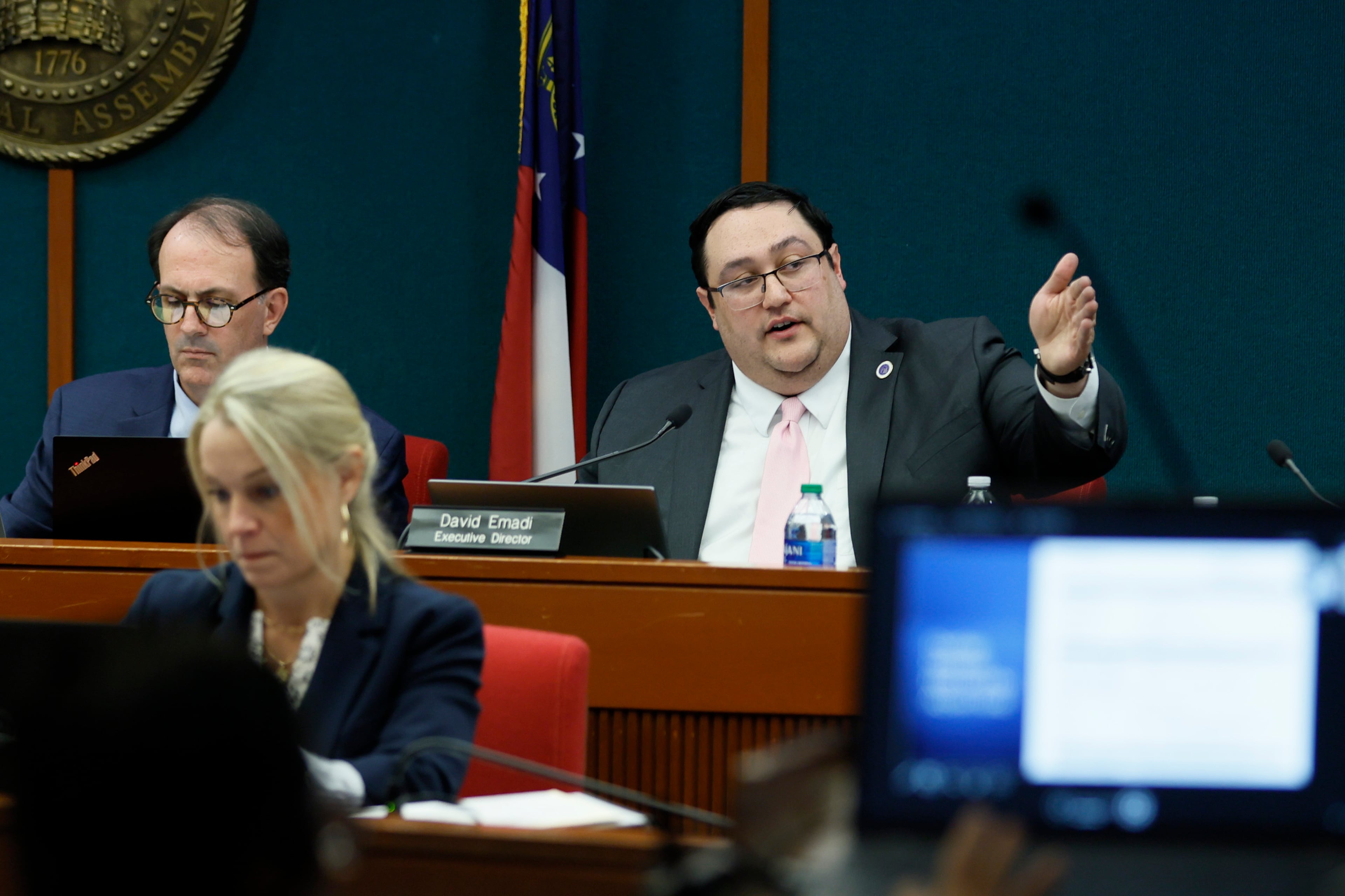 David Emadi, the executive director of the Georgia State Ethics Commission, points at the screen during his presentation at the Ethics Commission meeting held at the Coverdell Legislative Office Building on Jan. 15, 2025. A voting rights group founded by Stacey Abrams will pay $300,000 for unlawfully supporting her 2018 gubernatorial campaign. (Miguel Martinez/AJC)