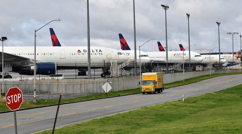 March 21, 2020 Atlanta - Several Delta Air Lines aircrafts parked near their headquarters at the HartsfieldâJackson Atlanta International Airport on Saturday, March 21, 2020. More than 13,000 Delta Air Lines employees have volunteered to take unpaid leave, and the company is taking out billions of dollars in loans as travel plummets and borders close due to the coronavirus pandemic. (Hyosub Shin / Hyosub.Shin@ajc.com)