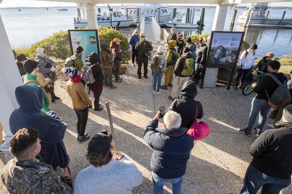 National Park Service Ranger Henry Smith (top center) gives an orientation briefing to passengers and guests before they board the Cumberland Island ferry in St. Marys. The 300-person ferry connects the barrier island to civilization. (Stephen B. Morton for the AJC 2022)