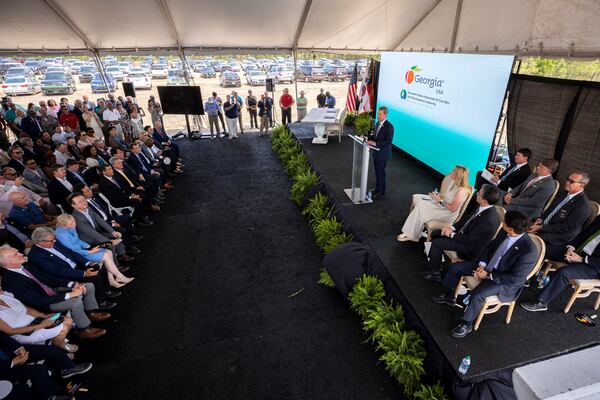 Gov. Brian Kemp, center right, announces that South Korean automaker Hyundai Motor Group is building an electric-vehicle plant in Ellabell, near Savannah. The Republican has hammered Georgia's two Democratic U.S. senators, Jon Ossoff and Raphael Warnock, over a provision of the climate and health care bill that Congress passed last year because it only provides a tax break to customers for electric vehicles assembled in the U.S. The Hyundai “Metaplant” won't be operational until 2025, so the tax break won't apply to its vehicles until then. (AJC Photo/Stephen B. Morton)