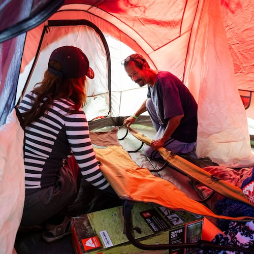 Evacuees Rodger Macias, right, and his wife Alendera Marcias set up a tent outside the Elks Lodge in Garden Grove, Calif., on Monday, May 25, 2026. (AP Photo/Ethan Swope)