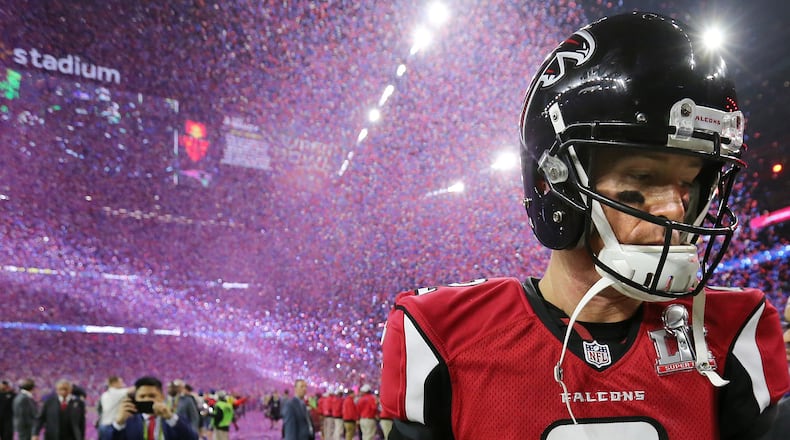 A dejected Matt Ryan walks off the field as the confetti falls to celebrate the Patriots' 34-28 in the 2017 Super Bowl.