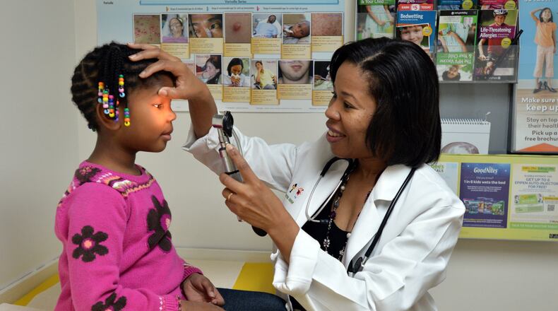 Dr. Melinda Willingham examines Kaiden Whisby, 5, at Decatur Pediatrics. BRANT SANDERLIN / BSANDERLIN@AJC.COM