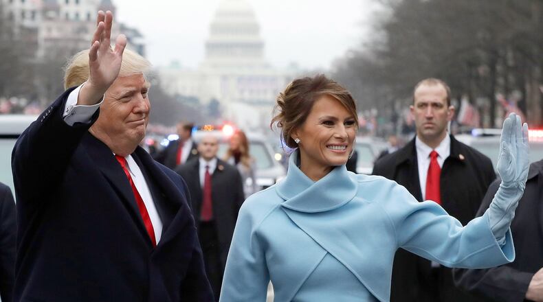 President Donald Trump waves to supporters as he walks the parade route with first lady Melania Trump after being sworn into office Friday in Washington, D.C. (Photo by Evan Vucci - Pool/Getty Images)