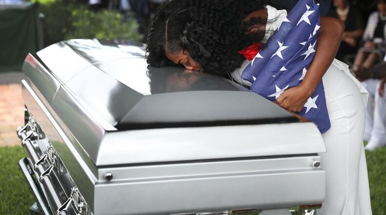 Myeshia Johnson kisses the casket of her husband, U.S. Army Sgt. La David Johnson, during his burial service at the Memorial Gardens East cemetery on Oct. 21, 2017, in Hollywood, Fla. Sgt. Johnson and three other American soldiers were killed in an ambush in Niger on Oct. 4. JOE RAEDLE / GETTY IMAGES