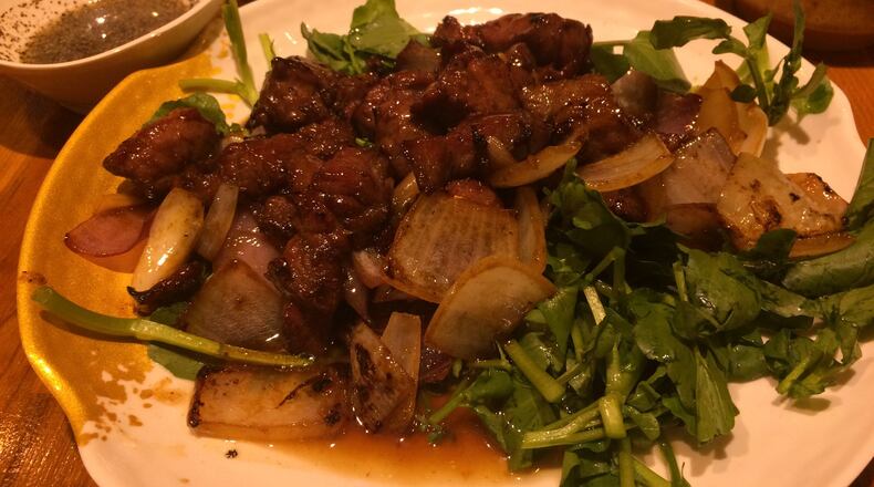 The thing that makes the shaking beef at Anh’s Kitchen is the white onion and lime sauce (to the left). CONTRIBUTED BY WENDELL BROCK