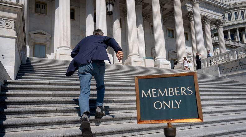 Rep. Darrell Issa, R-Calif., rushes up the steps at the Capitol for final votes before the House of Representatives leaves for a five-week recess, in Washington, Thursday, July 23, 2026. (AP Photo/J. Scott Applewhite)