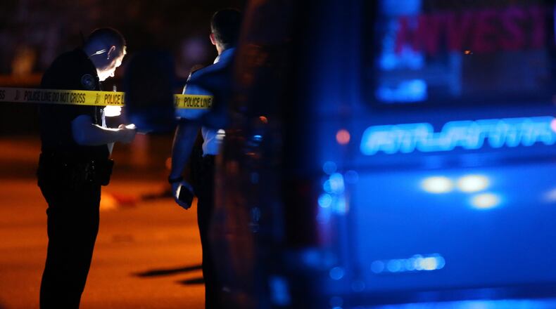 Atlanta police investigators work the scene on Kipling Street, where a man was shot in the head Wednesday night. The victim died from his injuries. BEN GRAY / BGRAY@AJC.COM