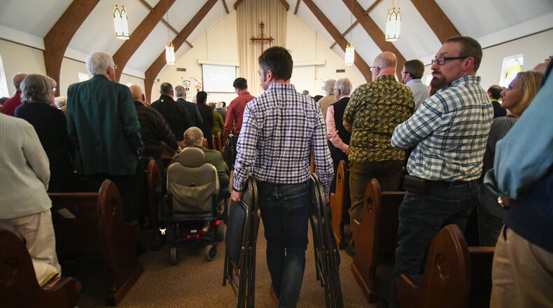 A volunteer brings extra seats into the sanctuary as clergy, laity, and members meet for a district gathering of The United Methodist Church, held at Kennesaw United Methodist Church on March 17, 2019. The UMC voted to maintain and strengthen its stance against gay marriage and gay clergy during a special session of the General Conference in February. This meeting provided a chance for members to hear and ask questions., take communion together, and worship. JOHN AMIS/for the AJC