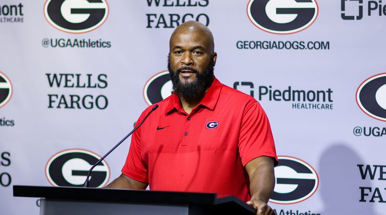 UGA running backs coach Dell McGee, here speaking to reporters at a news conference early in preseason camp, revealed Sunday that freshman Andrew Paul has been sidelined for the season with a knee injury. (Photo by Tony Walsh/UGA Athletics)