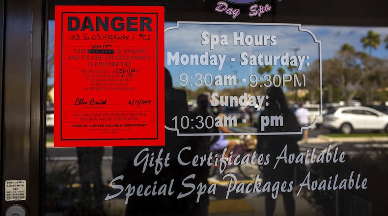 The shuttered Orchids of Asia Day Spa, where the city’s building department placed a danger sign on its front door that reads, “This unit is unsafe and its use or occupancy is prohibited,” in Jupiter, Fla., last month. SAUL MARTINEZ / THE NEW YORK TIMES