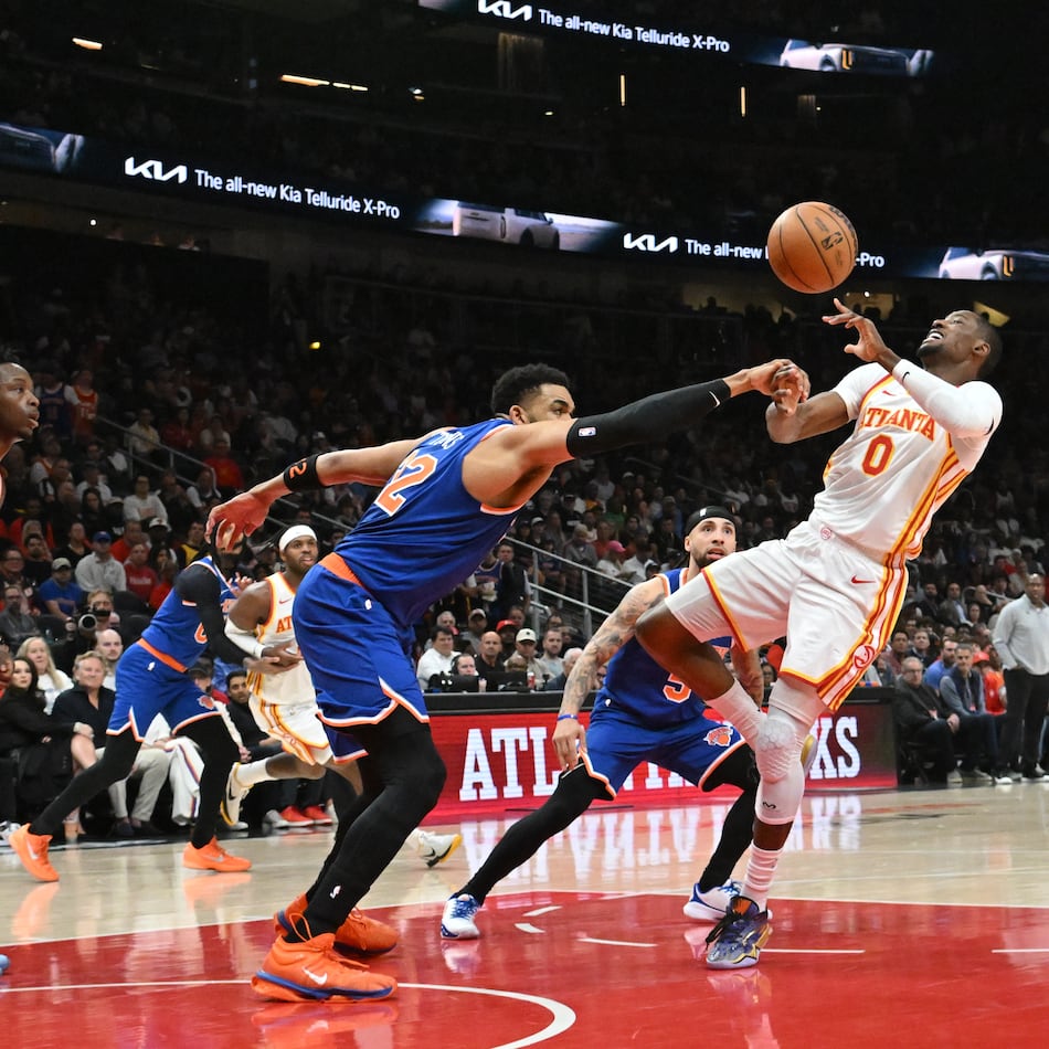 Knicks center/forward Karl-Anthony Towns (left) knocks the ball away from Hawks forward Jonathan Kuminga during the first half of Game 6 of a first-round playoff series April 30, 2026, at State Farm Arena in Atlanta. (Hyosub Shin/AJC)