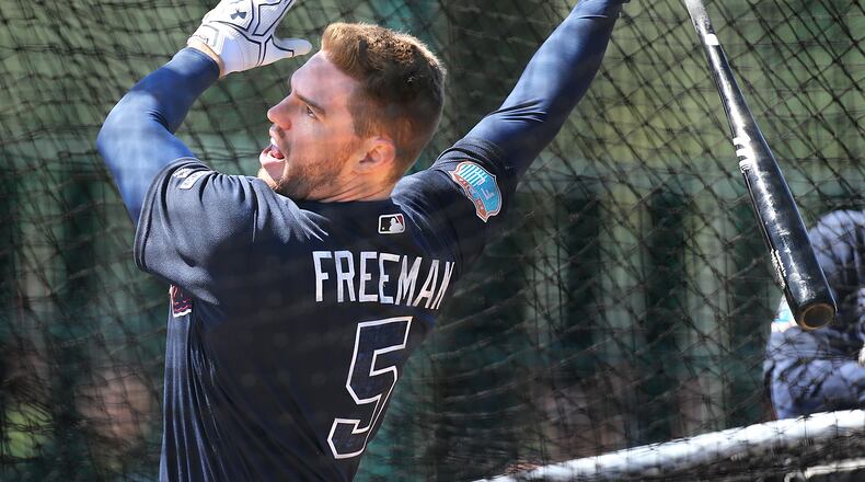 Braves first baseman Freddie Freeman hits during batting practice at spring training at Disney’s Wide World of Sports. Freeman said he has never wavered in his commitment to the Braves during their makeover. (Curtis Compton/ccompton@ajc.com)