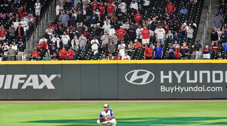 Braves center fielder Cristian Pache (25) watches as Philadelphia Phillies third baseman Alec Bohm (28) scores to give the Phillies a 7-6 lead in the ninth inning Sunday, April 11, 2021, at Truist Park in Atlanta. Atlanta argued Bohm didn't score on the play. (Hyosub Shin / Hyosub.Shin@ajc.com)