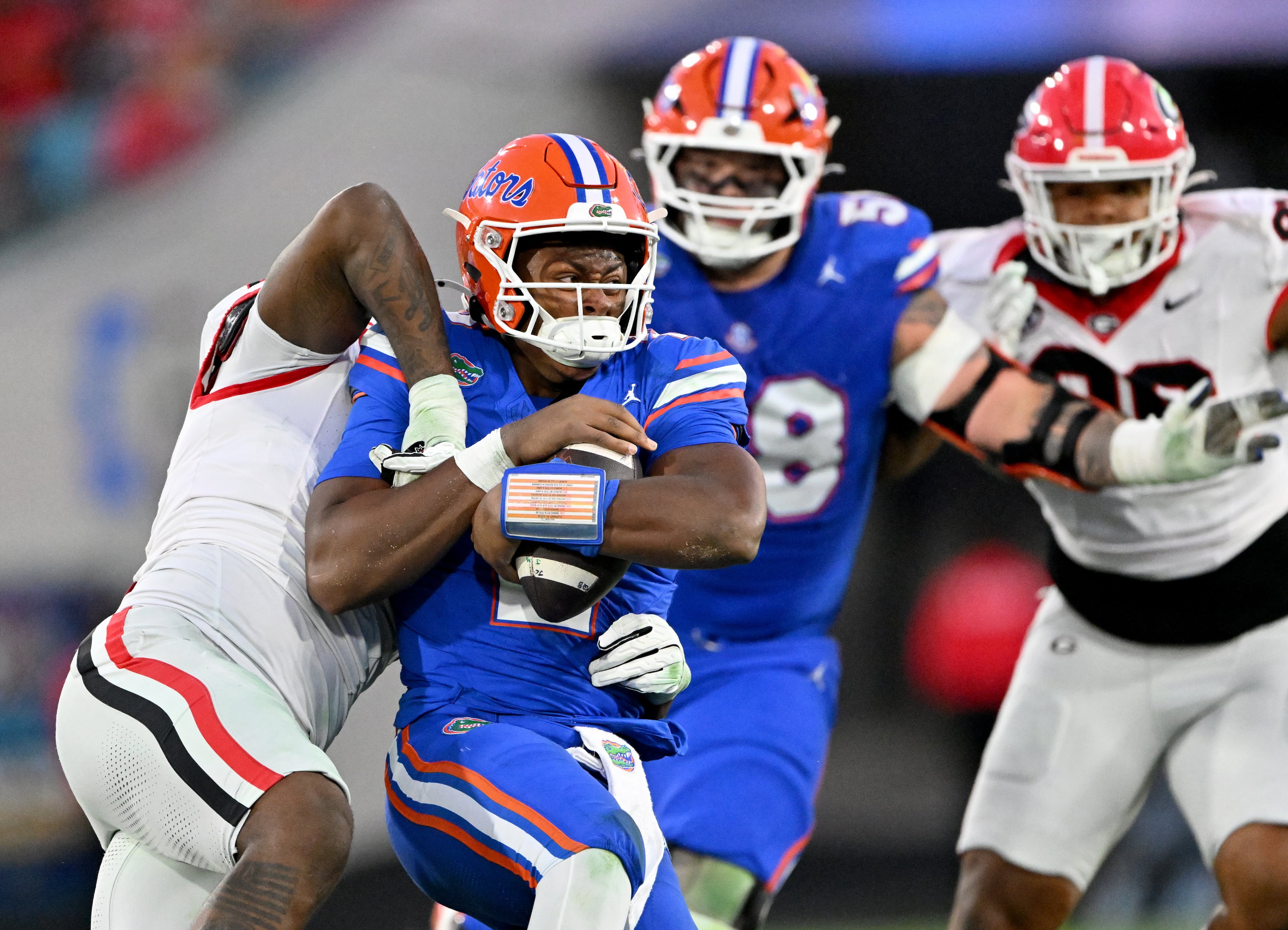 Florida quarterback DJ Lagway (2) is sacked by Georgia linebacker CJ Allen (left) during the second half in an NCAA football game, Saturday, November 1, 2025, Jacksonville, Fla. Georgia won 24-20 over Florida. (Hyosub Shin / AJC)
