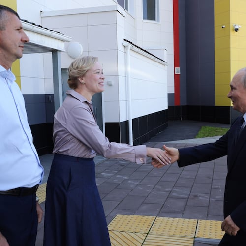 Russian President Vladimir Putin, right, visits the Secondary School named after the Hero of Russia Eduard Norpolov in Kurilsk on the Iturup Island, the largest of the Kuril Islands of Russia's fareast, on Thursday, Aug. 13, 2026. (Gavriil Grigorov, Sputnik, Kremlin Pool Photo via AP)