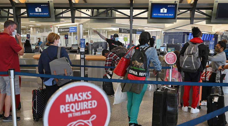 In this photo, Delta Air Lines employees assist customers in the Domestic Terminal at Hartsfield-Jackson Atlanta International Airport in Atlanta on Tuesday, October 5, 2021. (PHOTO by Hyosub Shin / Hyosub.Shin@ajc.com)