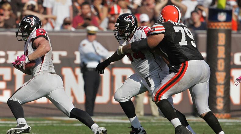 Atlanta Falcons defensive end Kroy Biermann (left) runs for a touchdown after intercepting a pass by Browns quarterback Jake Delhomme in the 4th quarter. The Falcons defeated the Browns, 20-10, at Cleveland Browns Stadium on Sunday, October 10, 2010, in Cleveland, Ohio.