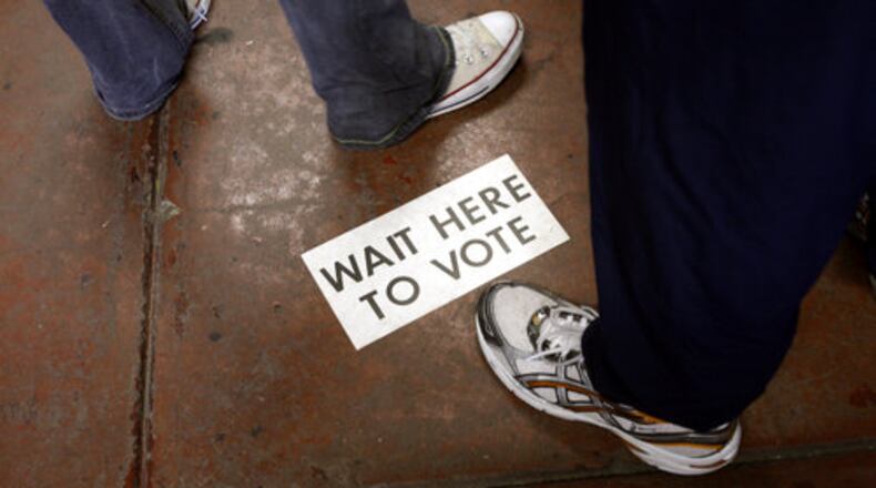 12:05 p.m. Atlanta: A sign on the floor of Atlanta Fire Department's station 20 in southwest Atlanta gives instructions for voters on Tuesday morning. The line snaked around the building in the morning, but by lunch had dwindled to about 15 people.