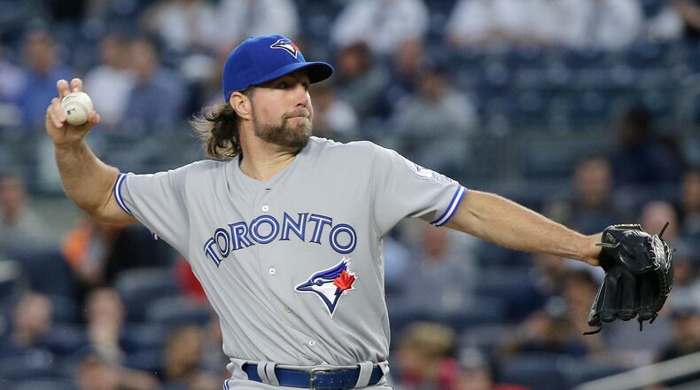 FILE - In this May 24, 2016, file photo, then-Toronto Blue Jays pitcher R.A. Dickey delivers against the New York Yankees during the first inning of a baseball game in New York. Former NL Cy Young Award winner R.A. Dickey and the Atlanta Braves have agreed to a one-year contract, adding a 42-year-old knuckleballer to a thin rotation as the team moves into a new ballpark. Dickey’s agreement, announced Thursday, Nov. 10, 2016, is subject to a successful physical. (AP Photo/Julie Jacobson, File)