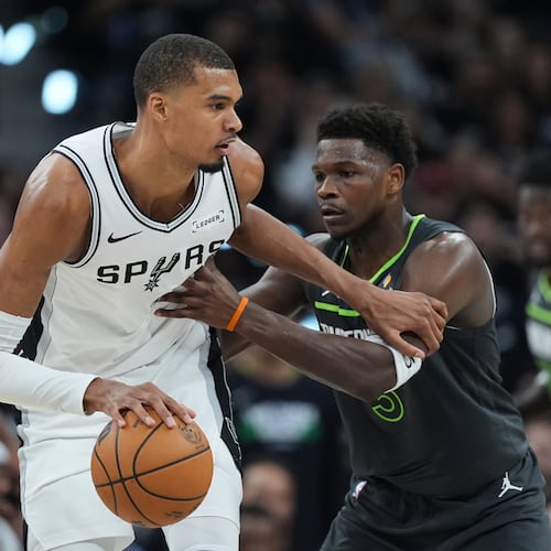 San Antonio Spurs forward Victor Wembanyama (1) drives against Minnesota Timberwolves guard Anthony Edwards (5) during the first half in Game 2 of a second-round NBA playoffs basketball series in San Antonio, Wednesday, May 6, 2026. (AP Photo/Eric Gay)