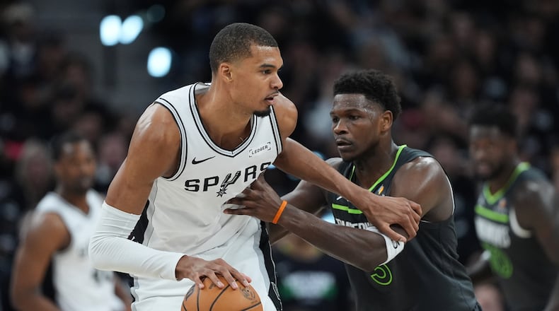 San Antonio Spurs forward Victor Wembanyama (1) drives against Minnesota Timberwolves guard Anthony Edwards (5) during the first half in Game 2 of a second-round NBA playoffs basketball series in San Antonio, Wednesday, May 6, 2026. (AP Photo/Eric Gay)