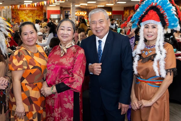 (From left) Linda Tran, Lisa Luong, Thien Tran and Von Tran attend the Thanksgiving festivities at the First Senior Center on Thursday, Nov. 20. As a family of eight, the Trans had trouble finding a sponsor abroad. (Jason Getz/AJC)