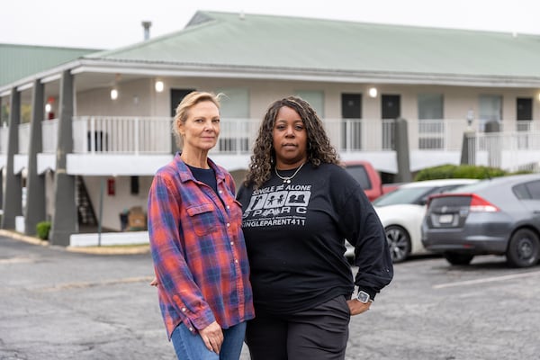 Community advocate Sue Sullivan and Joy Monroe, founder and CEO of Single Parent Alliance & Resource Center, outside the Economy Hotel Forest Park in Forest Park on Thursday, Nov. 14, 2024. (Arvin Temkar/AJC)