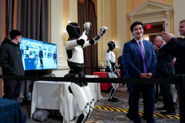 A Tesla robot is displayed as U.S. robotics companies look for congressional support to compete with Chinese companies, on Capitol Hill in Washington, Wednesday, March 26, 2025. (AP Photo/J. Scott Applewhite)