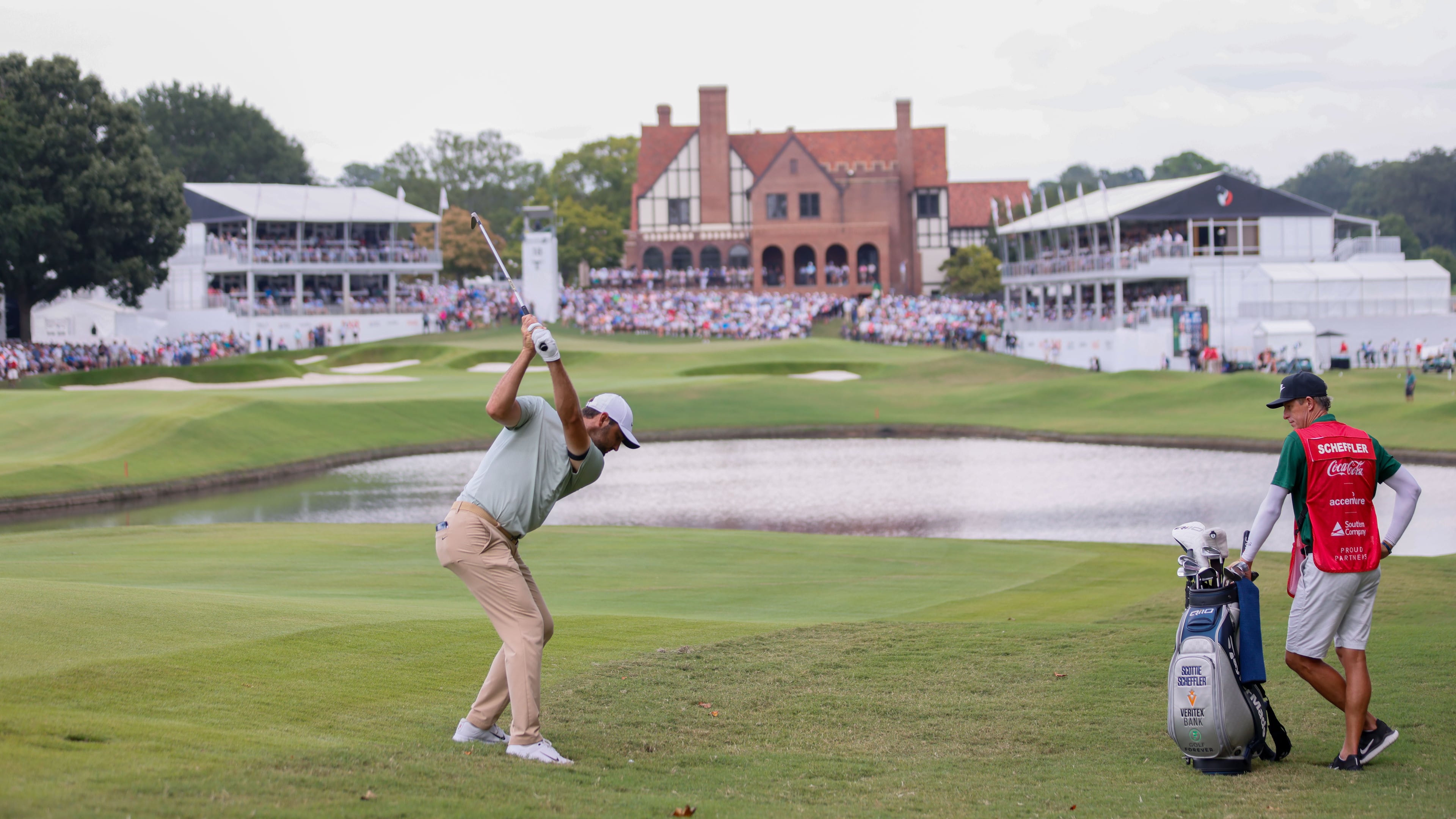 Scottie Scheffler hits his second shot on the 18th fairway during the final round of the Tour Championship at East Lake Golf Club last year. (Miguel Martinez / AJC)