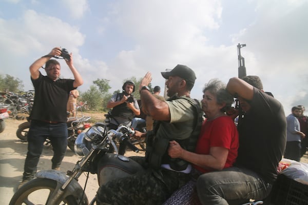 FILE -Hamas militants transport Adina Moshe, 72, inside the Gaza Strip after kidnapping her from her home in Nir Oz, a kibbutz in Israel near the Gaza border, on Oct. 7, 2023. (AP Photo), File)