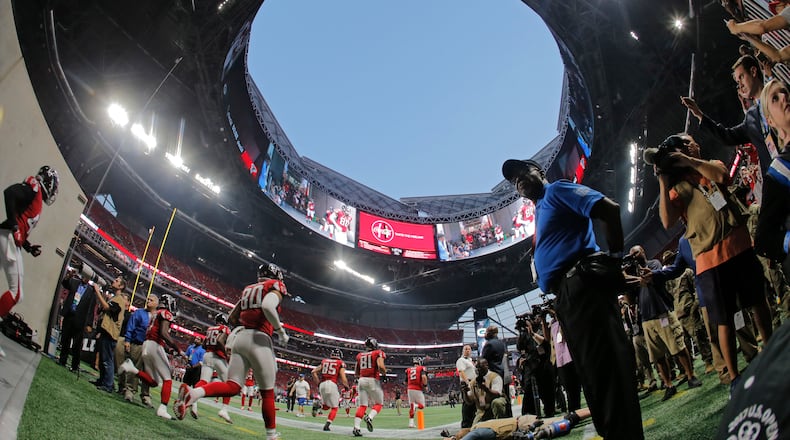 Falcons players enter the field for warmups before the Sept. 17 game against Green Bay, the only Falcons game played at Mercedes-Benz Stadium so far with the roof open.