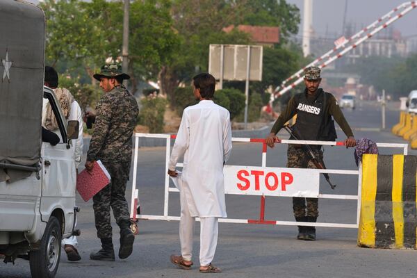 A Pakistani paramilitary soldier searches a vehicle as another stands guard at a checkpoint in Wagah, a joint border crossing point on the Pakistan and India border, near Lahore, Pakistan, Wednesday, April 30, 2025.(AP Photo/K.M. Chaudary)