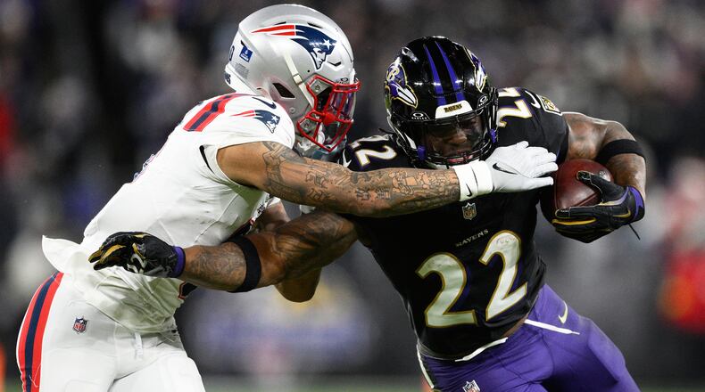 FILE - Baltimore Ravens running back Derrick Henry (22) runs against New England Patriots cornerback Christian Gonzalez during the second half of an NFL football game, Dec. 21, 2025, in Baltimore. (AP Photo/Nick Wass, File)
