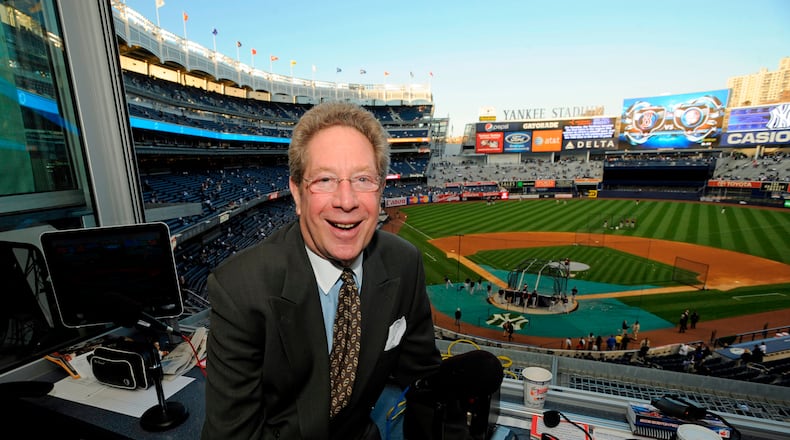 FILE - In this Sept. 25, 2009 file photo shows New York Yankees broadcaster John Sterling sitting in his booth before a baseball game against the Boston Red Sox at Yankee Stadium in New York. (AP Photo/Bill Kostroun, file)
