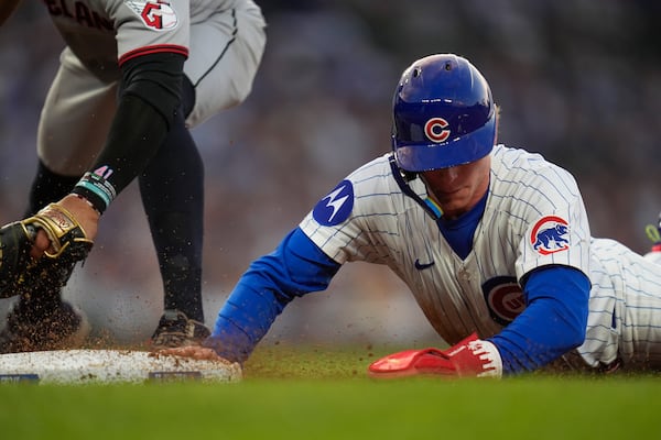 Cleveland Guardians first baseman Carlos Santana (41), left, tries to pick off Chicago Cubs' Pete Crow-Armstrong (4) during the third inning of a baseball game Wednesday, July 2, 2025, in Chicago. (AP Photo/Erin Hooley)