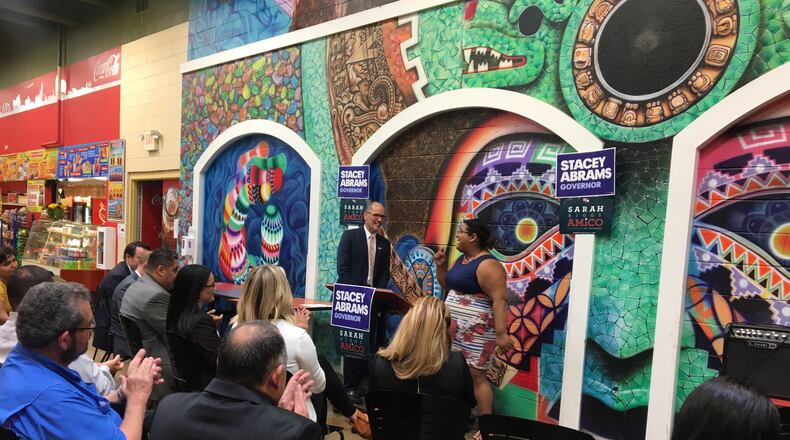 Democratic National Committee Chairman Tom Perez (left) and Genny Castillo, Latinx constituency director for the Coordinated Campaign of the Georgia Democratic Party, address Hispanic voters and candidates at Plaza Fiesta on Buford Highway on Wednesday, Aug. 15, 2018.