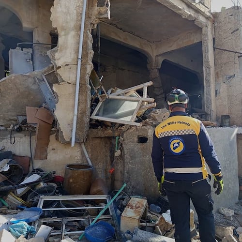 This photo provided by the Syrian Civil Defense, White Helmets, Syrian Civil Defense workers check a house that was destroyed during an Israeli forces raid in the southern Syrian village of Beit Jin, Syria, Friday, Nov. 28, 2025. (Syrian Civil Defense White Helmets via AP)