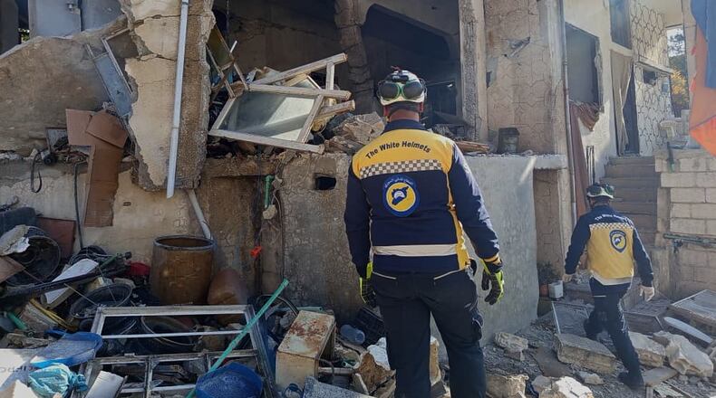 This photo provided by the Syrian Civil Defense, White Helmets, Syrian Civil Defense workers check a house that was destroyed during an Israeli forces raid in the southern Syrian village of Beit Jin, Syria, Friday, Nov. 28, 2025. (Syrian Civil Defense White Helmets via AP)