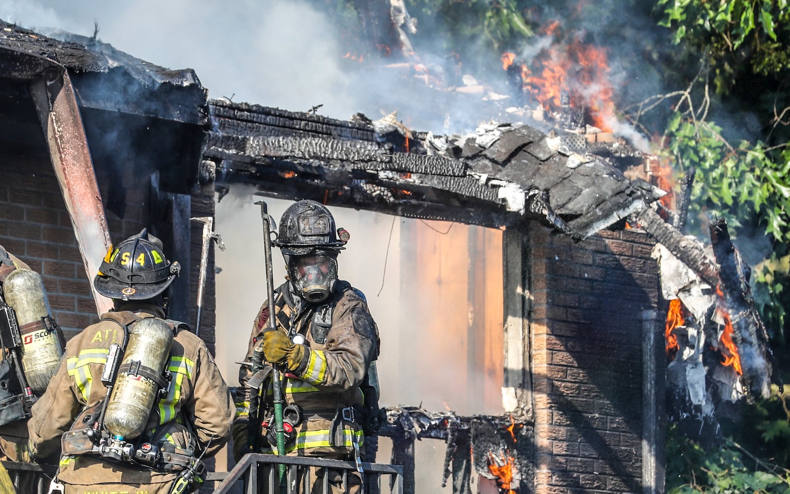 July 7, 2022 Atlanta: Atlanta firefighters had a hot morning battling an apartment blaze in the 2200 block of Campbellton Road in Atlanta on Thursday, July 7, 2022. The call came in at 9 am for the Adams House Apartments where units arrived to heavy smoke conditions according to Atlanta Fire Rescue Captain Taurus Durrah. Flames erupted from the bottom floor to the top floor and then the attic Durrah said. Crews initially had to bring in tank water to get water on the fire because of the 800 foot distance to the hydrant on Campbellton Road. Four units were damaged and 8-families displaced. No one was injured and the fire is under investigation. Durrah said more units are being sent to fire scene to shorten the rotation of fire crews due to the heat. Firefighters are told to hydrate  and stay cool a full shift before coming to work to combat the heat. (John Spink / John.Spink@ajc.com)


