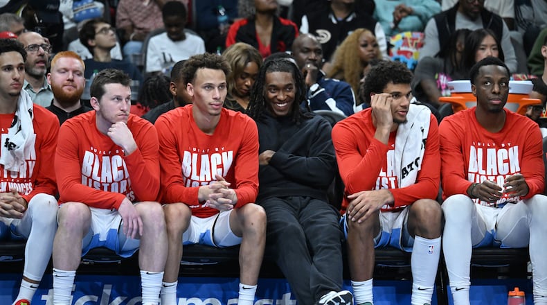 Atlanta Hawks new guard Terance Mann (center) smiles as he sits with teammates during the second half in an NBA basketball game at State Farm Arena, Friday, February 7, 2025, in Atlanta. Atlanta Hawks won 115-110 over Milwaukee Bucks. (Hyosub Shin / AJC)