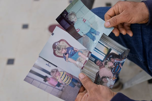 Khalid Ahmad, holds childhood photos of his son, Waleed, at his family home in the West Bank town of Silwad, northeast of Ramallah, Wednesday, March 26, 2025. (AP Photo/Nasser Nasser)