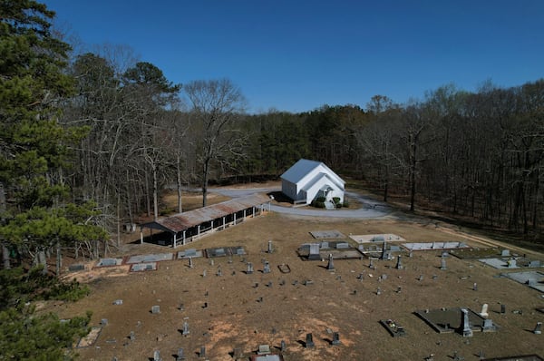 Trees encircle Holly Springs Primitive Baptist Church, which has been a historical meeting site for Sacred Harp singers for generations, in Bremen, Ga., on Sunday, March 23, 2025. (AP Photo/Jessie Wardarski)
