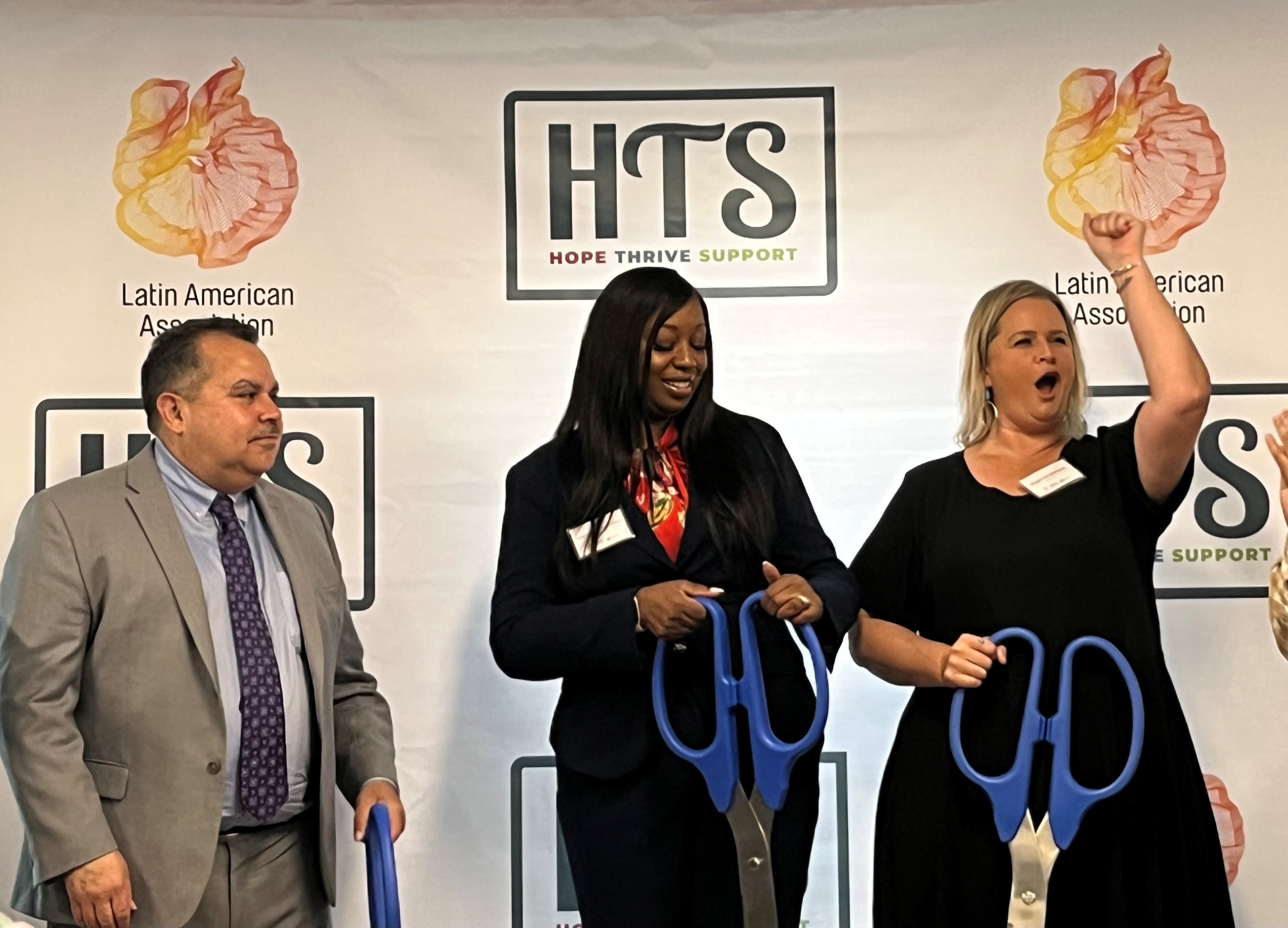 Santiago Marquez, Nicole Love Hendrickson, and Megan VandeBorgert celebrate following a ribbon-cutting ceremony of a new homeless shelter and Latin American Association Gwinnett Outreach Center in Norcross on Monday, May 19, 2025. (Lautaro Grinspan/AJC)